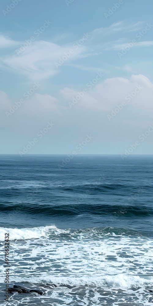 Fototapeta premium Blue Sky and Ocean Waves Crashing on the Shore