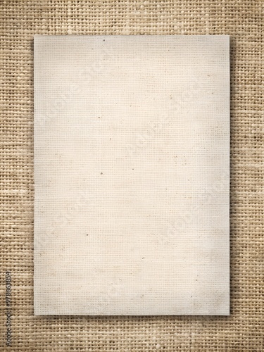 Sheet of paper on burlap texture background. Template for creative design