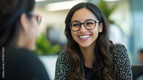A friendly bank employee smiling while discussing loan options with a customer in a modern bank office.