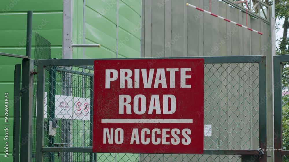 A small monkey runs across a gate with a red A small monkey runs across a gate with a red