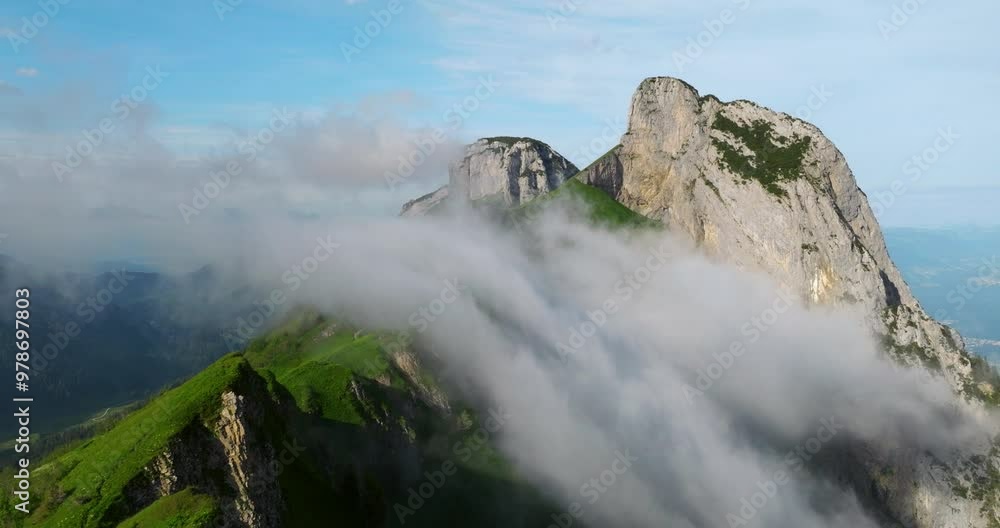 Rocky Swiss Alps With Covered By Clouds In Saxer Lucke, Switzerland. - aerial shot Rocky Swiss Alps With Covered By Clouds In Saxer Lucke, Switzerland. - aerial shot