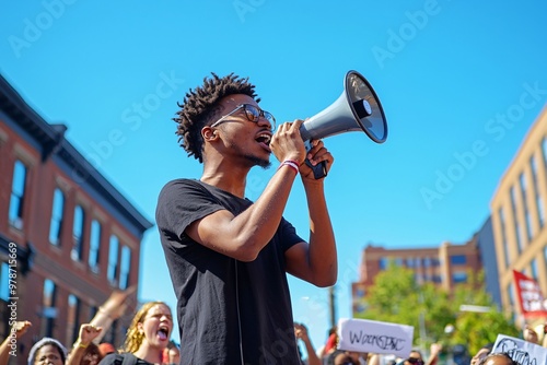 An enthusiastic advocate energizes a gathering for social reform, passionately speaking out against a backdrop of a bright, open sky. photo