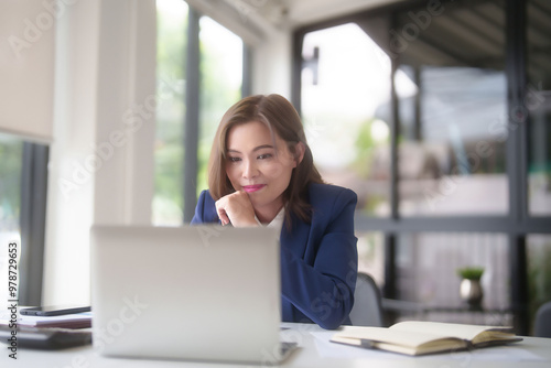 Free Download Asian businesswomen typing on keyboard laptop to researching business data and thinking about strategy of new business while analyze investment and market stock of new startup in outside office - GFXLoad
