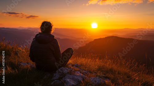 A peaceful evening spent watching a stunning sunset over a tranquil landscape in the mountains