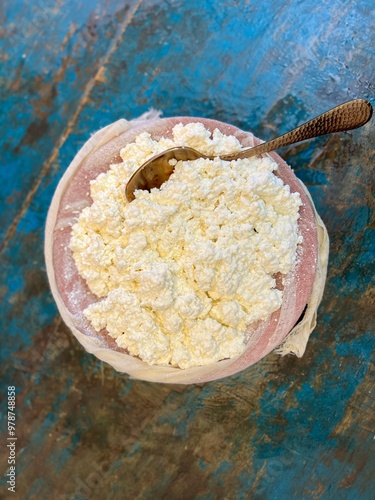 Fresh grainy cottage cheese (curds or whey) is a curdled milk, diary product. Soft cottage cheese whey close-up photo