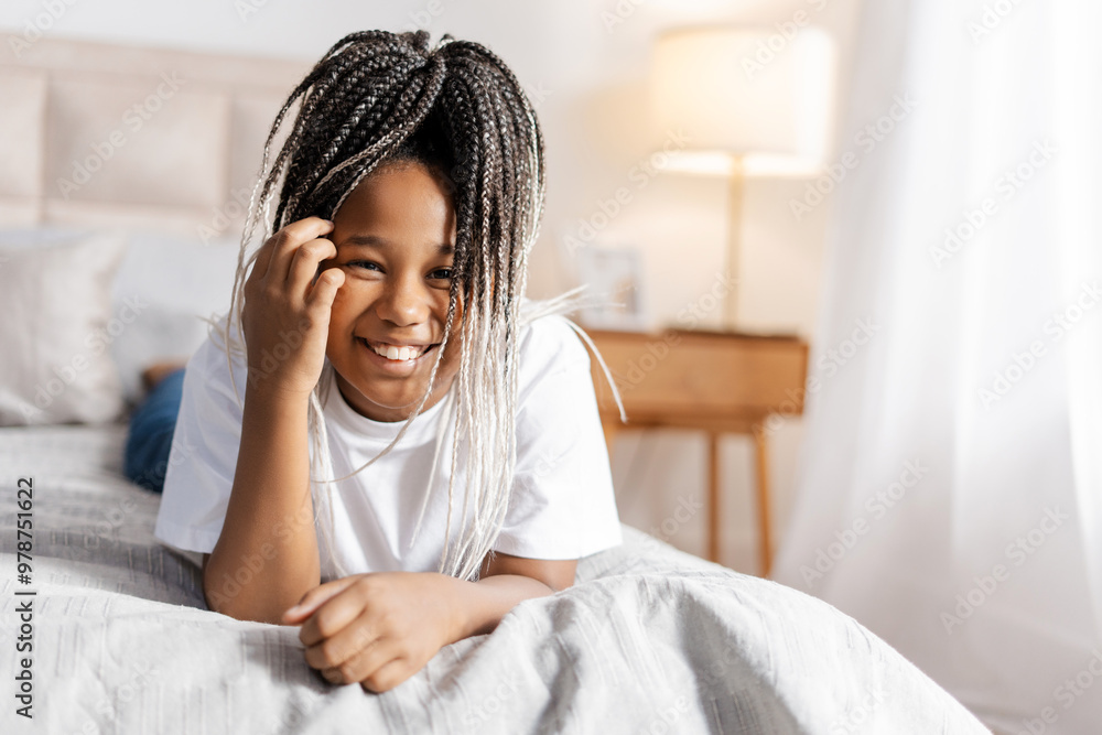 Happy teenager girl lying on the bed and looking at camera at home Happy teenager girl lying on the bed and looking at camera at home