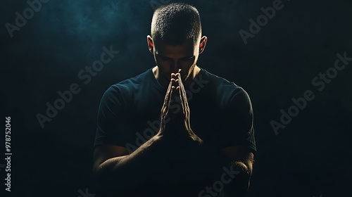 God, worship and man with hands praying for help, hope and guidance in dark studio. Pray, thank you and Christian male in prayer for hope, gratitude and holy praise, faith or blessing to Jesus