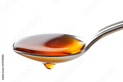 A shiny spoon with maple syrup dripping, isolated on a white background, studio shot.