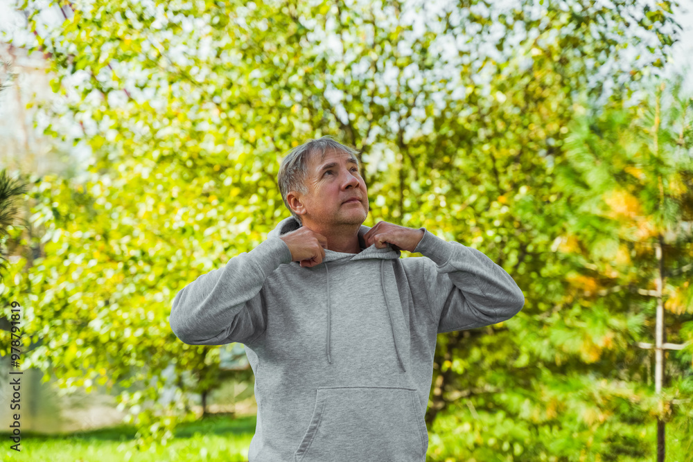 Portrait of an elderly man running in a public park