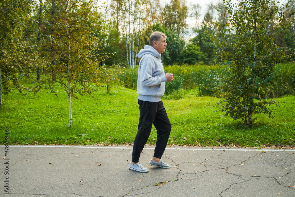 Portrait of an elderly man running in a public park Portrait of an elderly man running in a public park