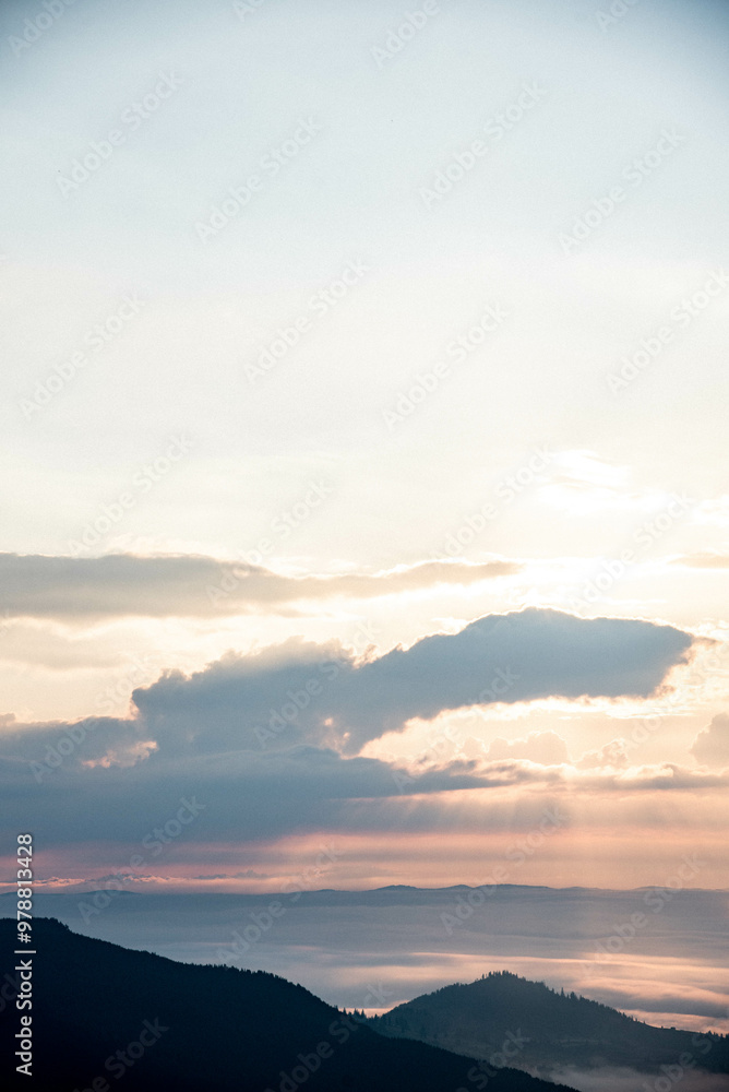 Majestic Mountain Landscape Covered in Mist with Sun Rays Breaking Through Clouds Majestic Mountain Landscape Covered in Mist with Sun Rays Breaking Through Clouds