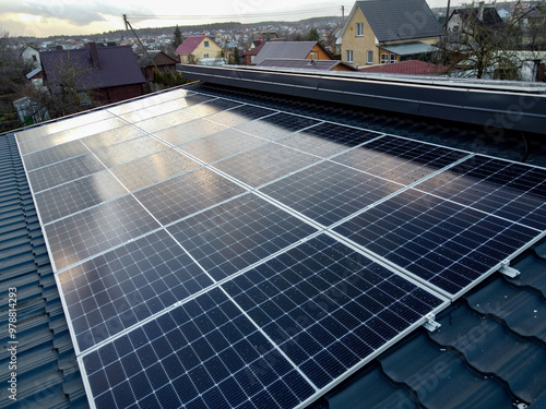 Solar panels on pitched metal roof. Home Renewable Energy Systems. Solar Rooftop System. Photovoltaic Roofing