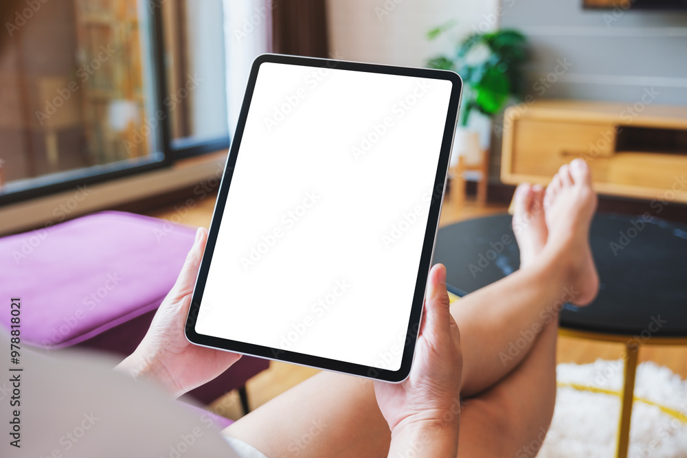 Mockup image of a woman holding digital tablet with blank desktop screen at home Mockup image of a woman holding digital tablet with blank desktop screen at home