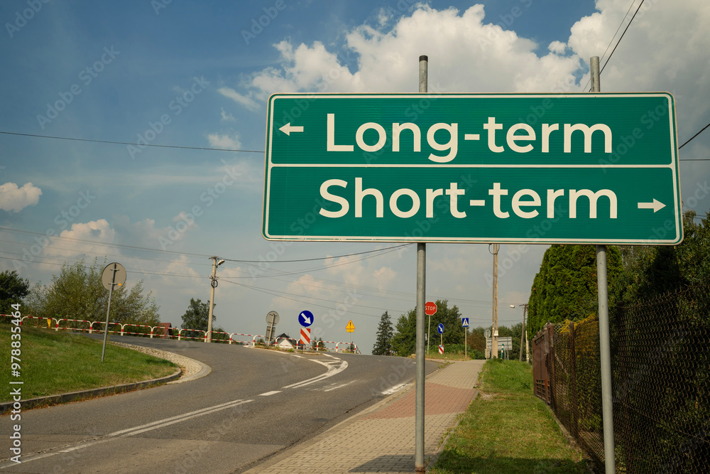 Tablica informacyjna przy drodze Long-term, Short-term w słoneczny dzień.