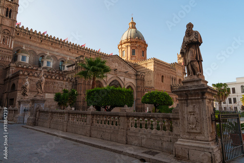 Fototapeta Naklejka Na Ścianę i Meble -  Wide view of Palermo Cathedral in Sicily, showcasing its impressive dome, detailed facade, and the lively plaza in front during a sunny day