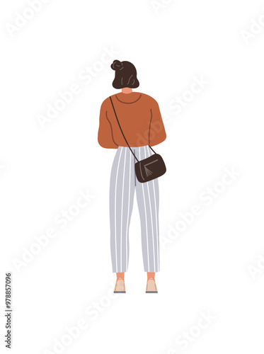 A young woman with brown hair in a bun wears a brown top, high-waisted striped pants, and a small black crossbody bag while walking away. Ideal for fashion, casualwear, lifestyle, city life