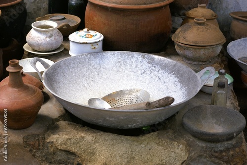 Old traditional javanese kitchen with metal wok and clay pots