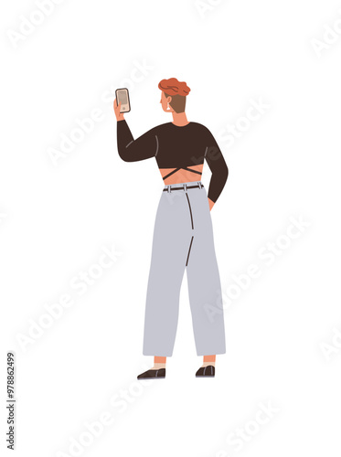A young individual with short hair is seen taking a selfie with a smartphone, dressed in a crop top and wide-leg pants. Ideal for youth culture, social media, fashion, modern tech, casual style