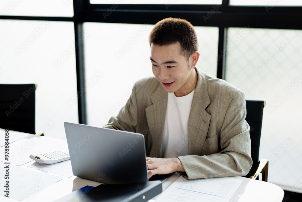 Young adult male Creative startup Gen z male working at coworking space. Young adult male Creative startup Gen z male working at coworking space.