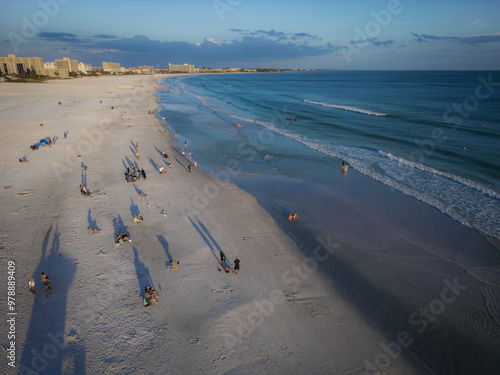 Aerial view of a beautiful sandy beach with people enjoying the sunset over the Gulf of Mexico, Siesta Key, Florida, United States. photo