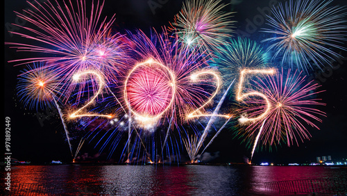 Sparkler 2025 text colorful firework illumination on dark blue sky background, happy new year 2025 concept