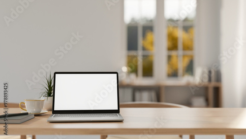 Wallpaper Mural A laptop with a white screen mockup on a wooden tabletop in a contemporary minimalist room. Torontodigital.ca