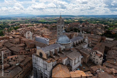 Aerial view of the beautiful historic city with medieval rooftops and the iconic cathedral, Siena, Italy. photo