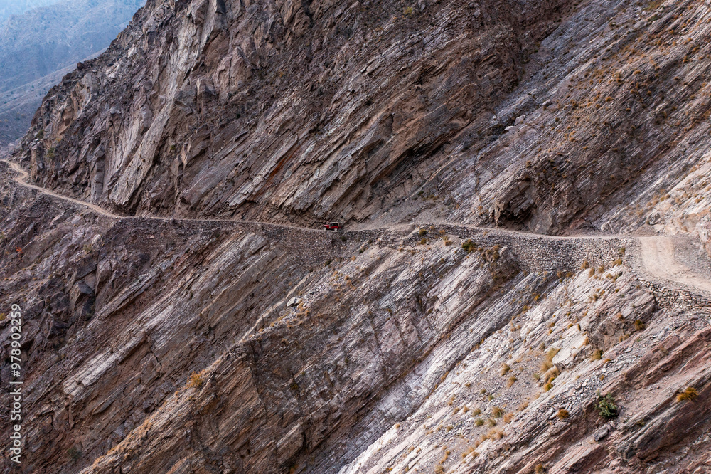 Aerial view of winding mountain road with rugged rock formations, Babu Sar, Pakistan. Aerial view of winding mountain road with rugged rock formations, Babu Sar, Pakistan.