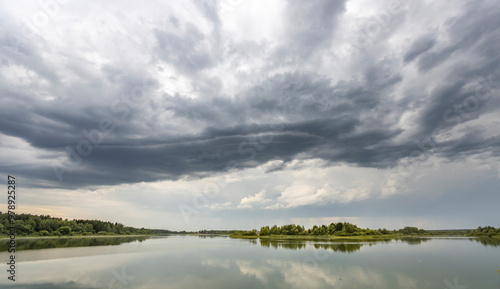 A cloudy sky with a lake in the background