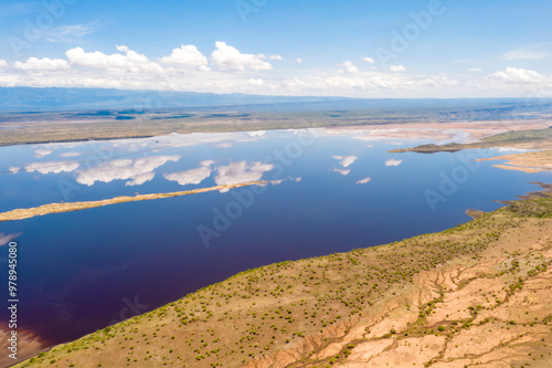 Aerial view of serene Lake Magadi with calm waters reflecting the sky and clouds, Magadi, Kenya. photo