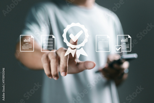 Fotografie Quality control and quality guarantee process concept, Person touching certificate icon on virtual screen for approve quality assurance and guarantee business
