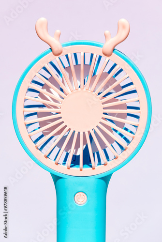 Colorful portable hand fan with whimsical antler design photo