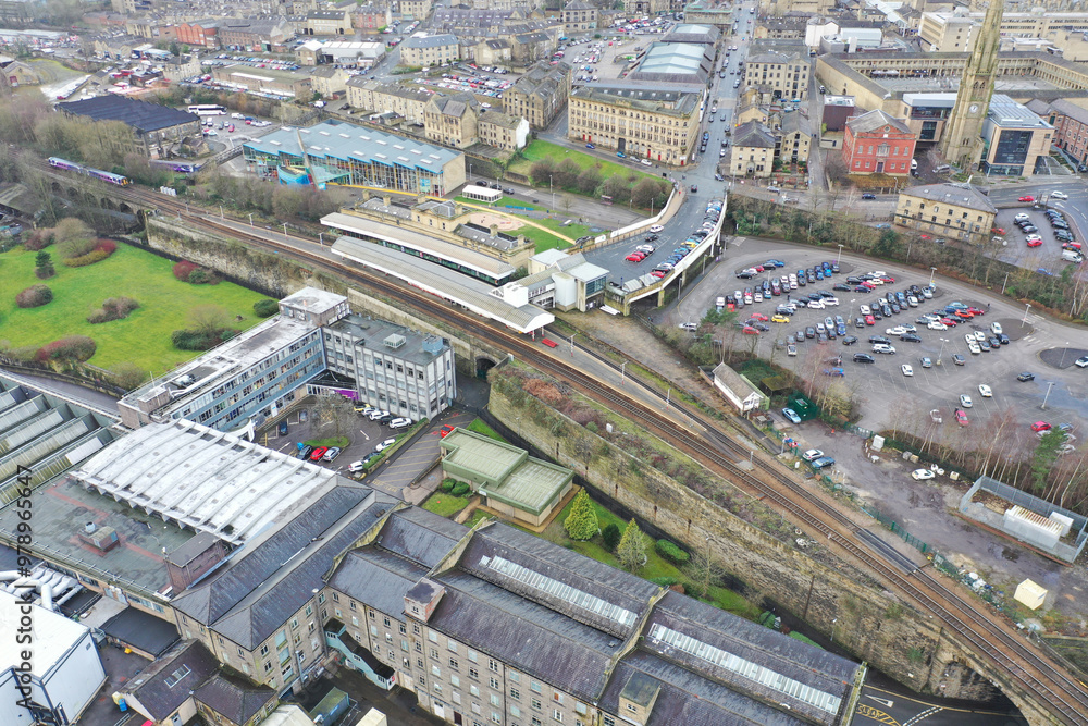 Obraz premium Aerial drone photo of the town centre of the town of Halifax in West Yorkshire showing the old historic buildings and train station on a foggy day in the winter time