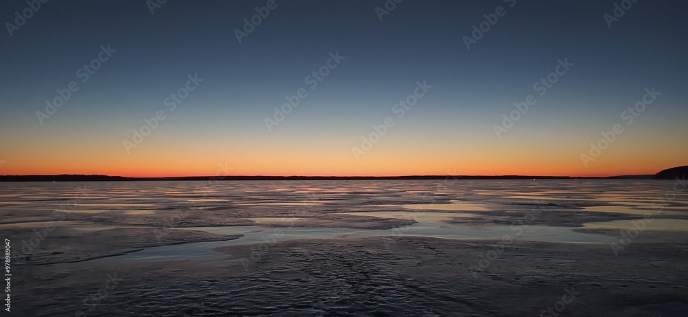 Fototapeta premium sunset over the frozen lake