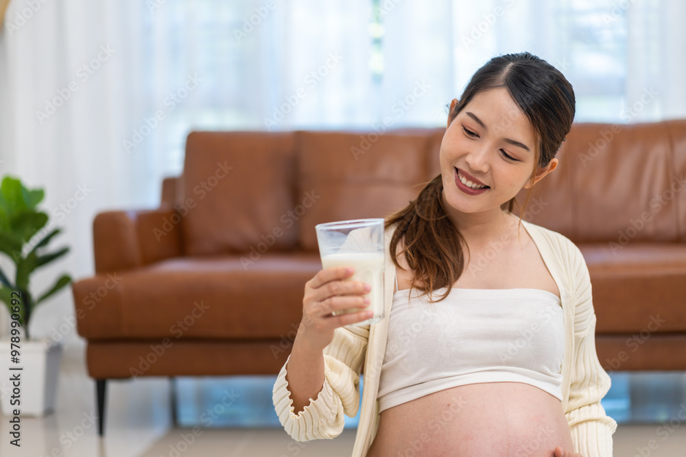 Happy smiling asian mother woman drinking fresh milk hugging with pregnancy baby in belly, woman pregnant, birth, preparation, maternity, protein, nutrition,calcium and vitamin.healthy concept Happy smiling asian mother woman drinking fresh milk hugging with pregnancy baby in belly, woman pregnant, birth, preparation, maternity, protein, nutrition,calcium and vitamin.healthy concept