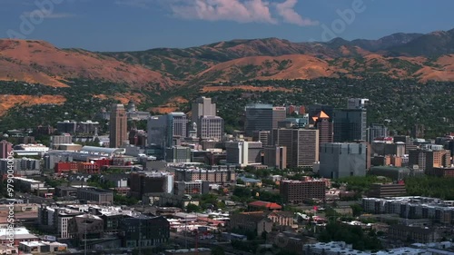 Downtown Salt Lake City SLC Utah USA Wasatch Mountain Range aerial drone circle left parallax summer blue sky morning afternoon LDS temple The Great Salt Basin Lake County region office buildings photo