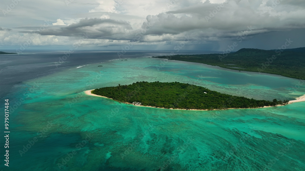 Aerial view of a pristine tropical island with azure lagoon and lush palms, Paonangisu, Vanuatu. Aerial view of a pristine tropical island with azure lagoon and lush palms, Paonangisu, Vanuatu.