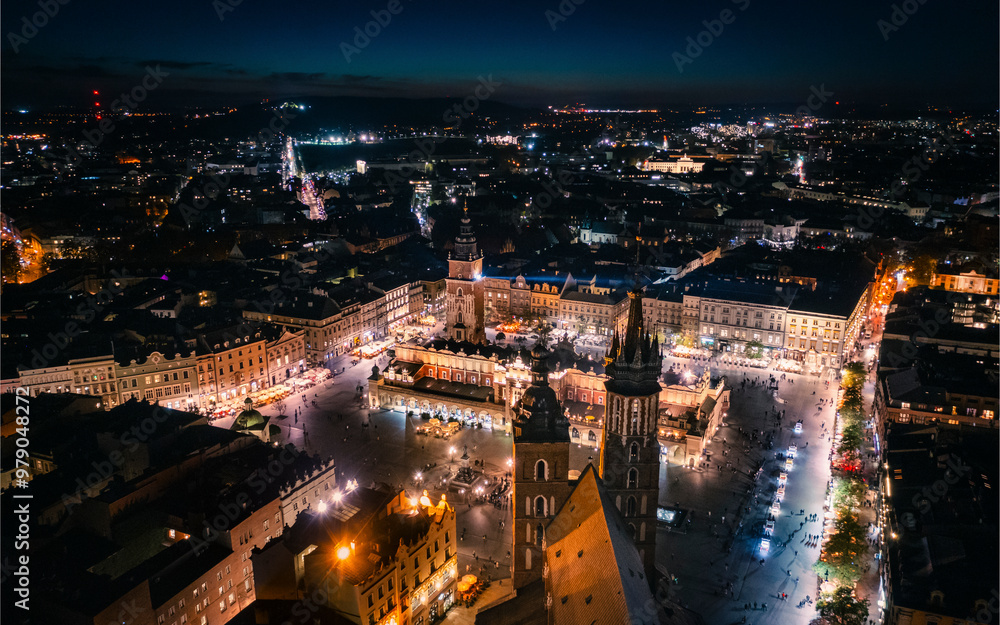 Aerial view of the illuminated Main Square featuring St. Mary's Church and Sukiennice, Krakow, Poland. Aerial view of the illuminated Main Square featuring St. Mary's Church and Sukiennice, Krakow, Poland.