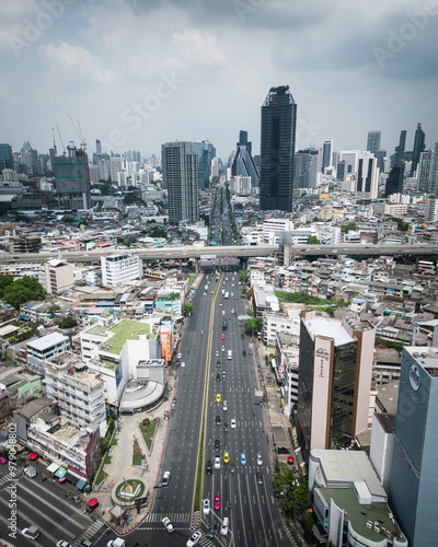 Aerial view of bustling downtown cityscape with modern skyscrapers and busy traffic, Bang Rak, Thailand. photo