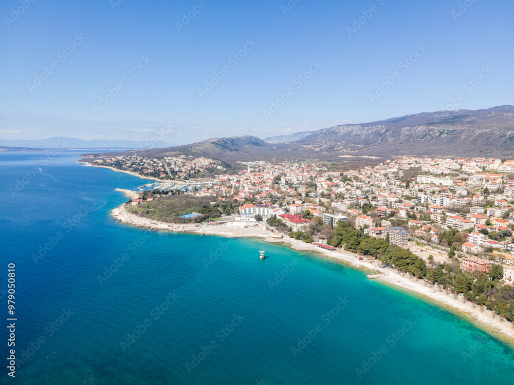 Aerial view of beautiful coastline and serene cityscape with azure sea and mountains, Novi Vinodolski, Croatia. Aerial view of beautiful coastline and serene cityscape with azure sea and mountains, Novi Vinodolski, Croatia.