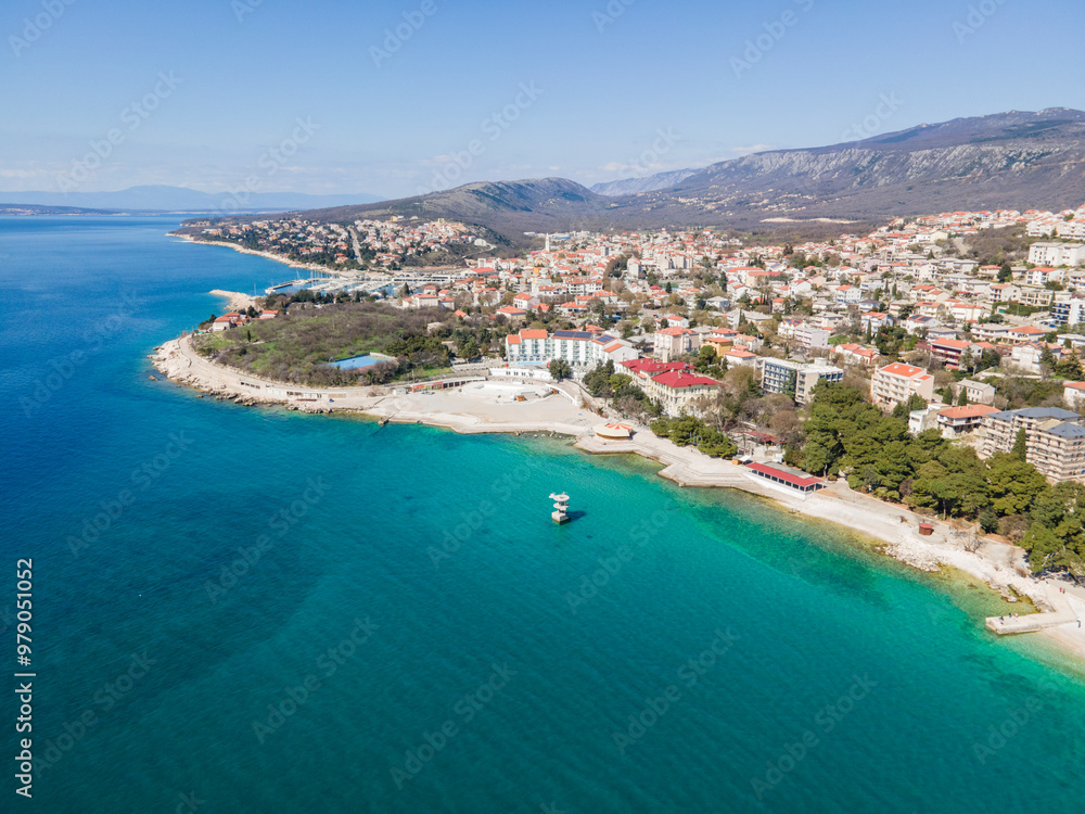 Aerial view of picturesque coastal city with serene beach and turquoise water, Novi Vinodolski, Croatia. Aerial view of picturesque coastal city with serene beach and turquoise water, Novi Vinodolski, Croatia.
