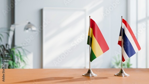 FLAGS OF BOLIVIA AND THAILAND ON TABLE