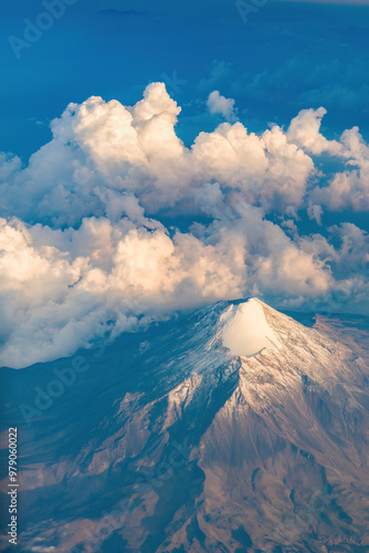 Aerial view of pico de orizaba volcano with snow capped peak and dramatic clouds, Tlachichuca, Mexico. photo