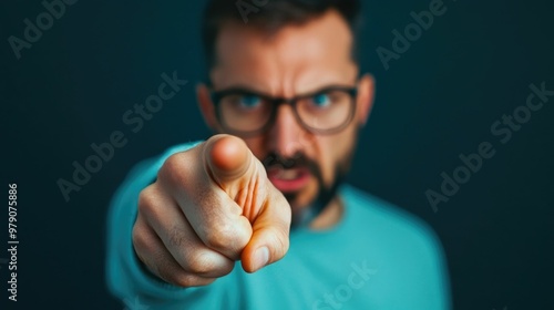 Close up of a man angrily pointing his finger during a heated argument or confrontation with a blurred background creating a deep depth of field effect photo