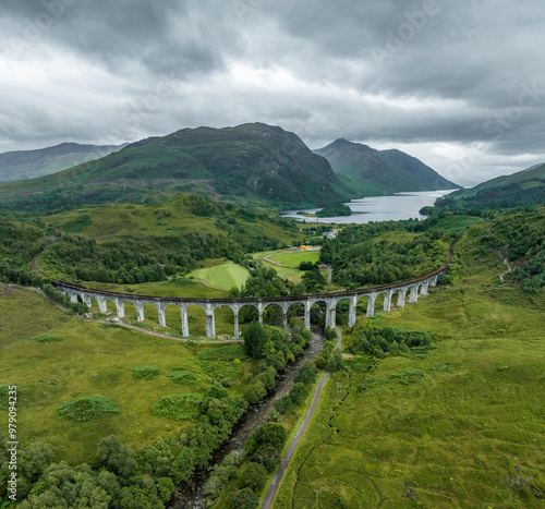 Aerial view of the iconic glenfinnan viaduct crossing lush valleys and majestic mountains, Glenfinnan, United Kingdom. photo