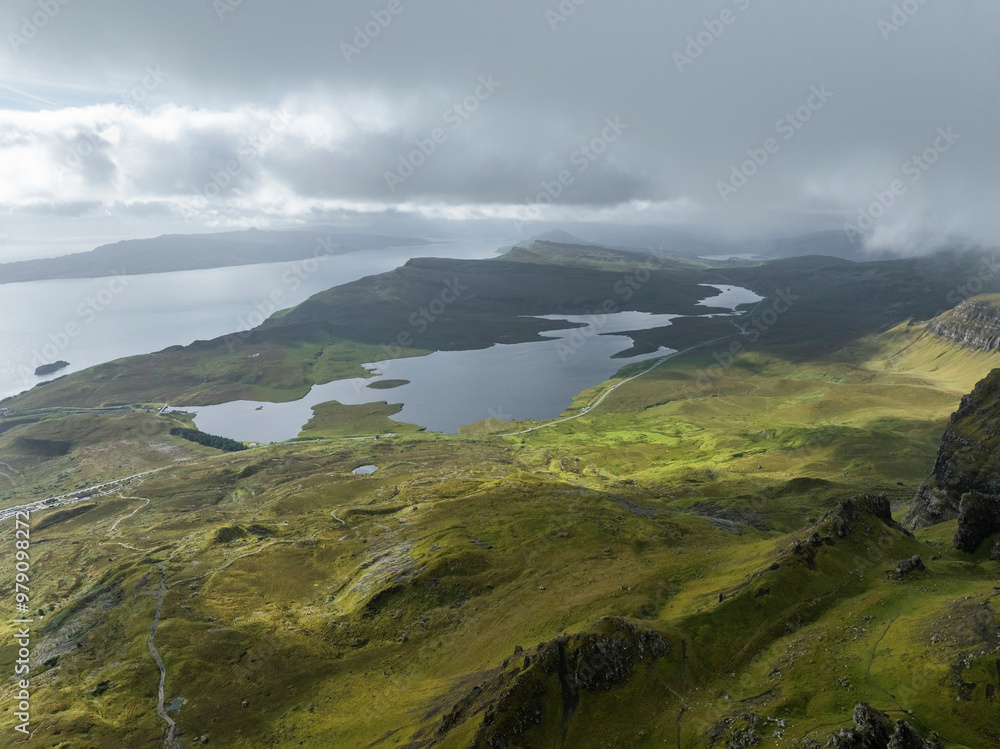 Aerial view of the majestic Old Man of Storr surrounded by rugged mountains and serene clouds, Portree, Scotland. Aerial view of the majestic Old Man of Storr surrounded by rugged mountains and serene clouds, Portree, Scotland.