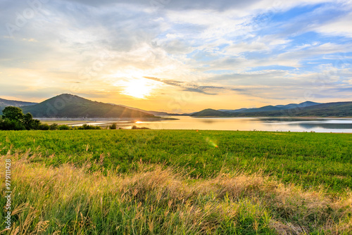 A beautiful landscape with a lake and a field of grass