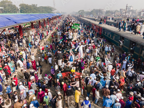 Dhaka, Bangladesh - 03 February 2024: Aerial view of overcrowded Bishwa Ijtema festival at Tongi rail station with trains and large groups of people, Dhaka, Bangladesh.