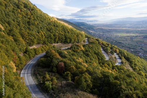 Aerial view of a picturesque winding road through serene mountains and lush greenery, Aetos, Greece. photo