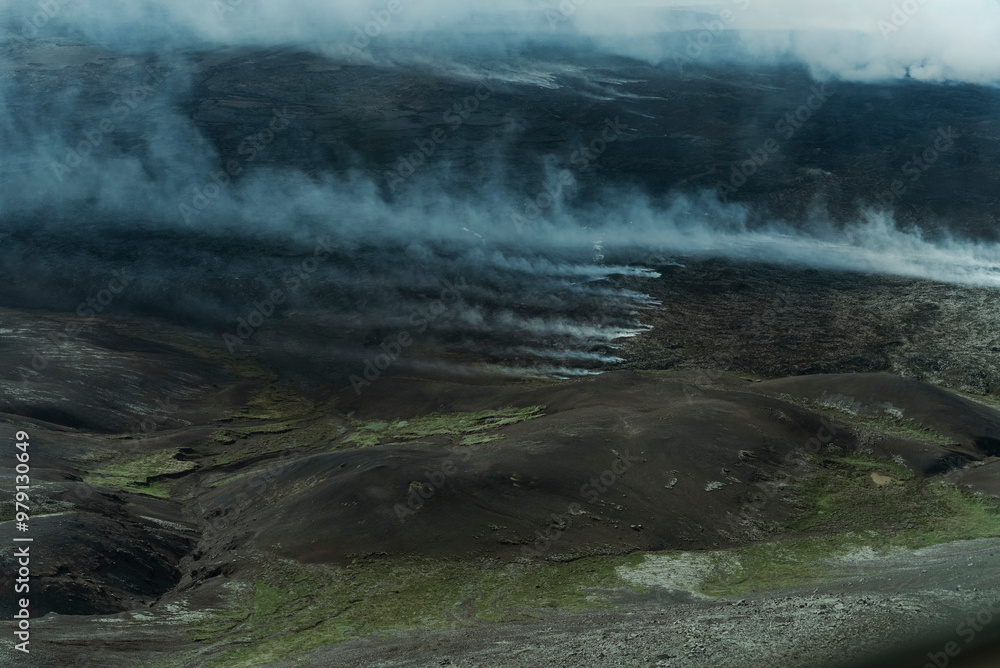 Aerial view of an active volcano with smoke and lava flow in a beautiful landscape, Grindavik, Iceland.